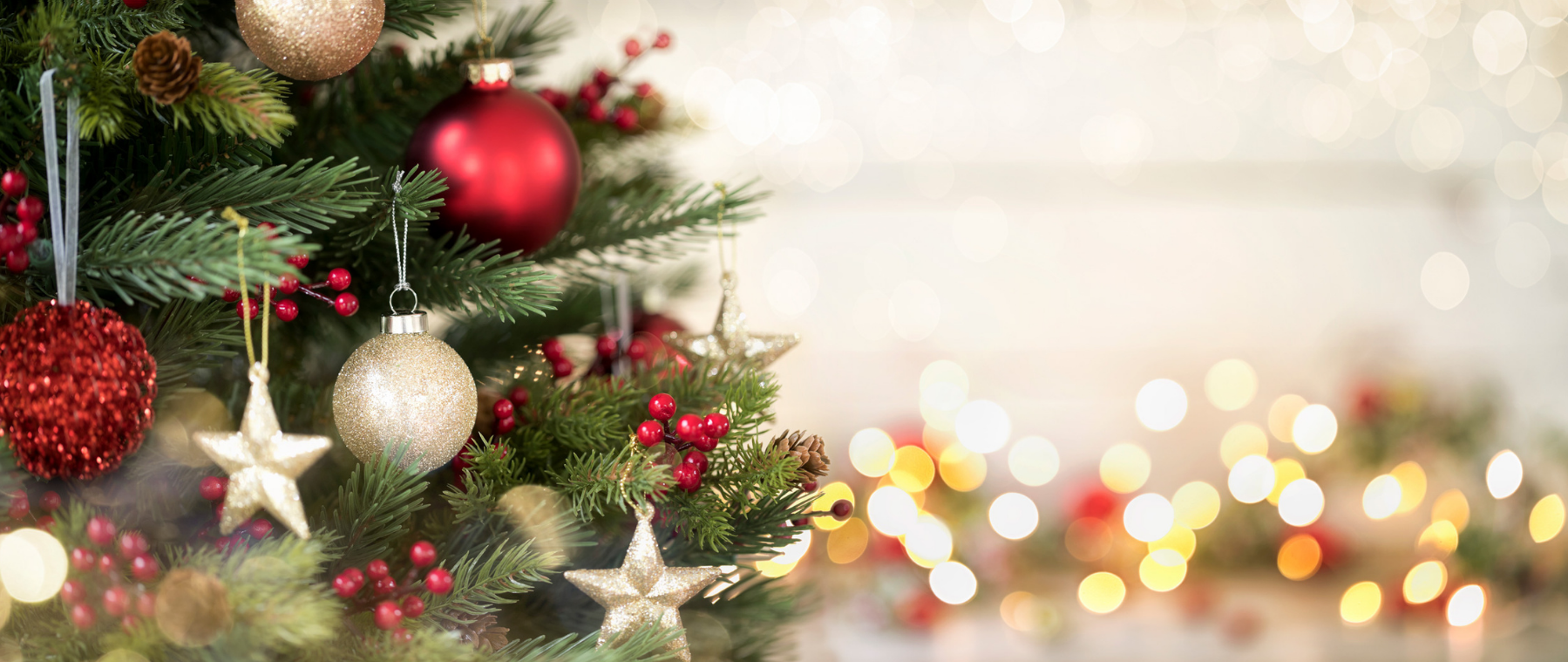 Decorated Christmas tree with ornaments and lights on a blurred background
